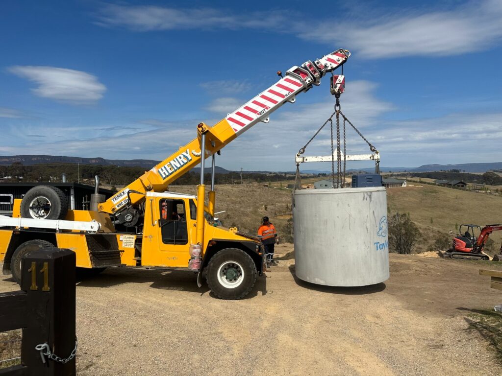 All Purpose Plumbing team placing a wastewater storage tank at a job site