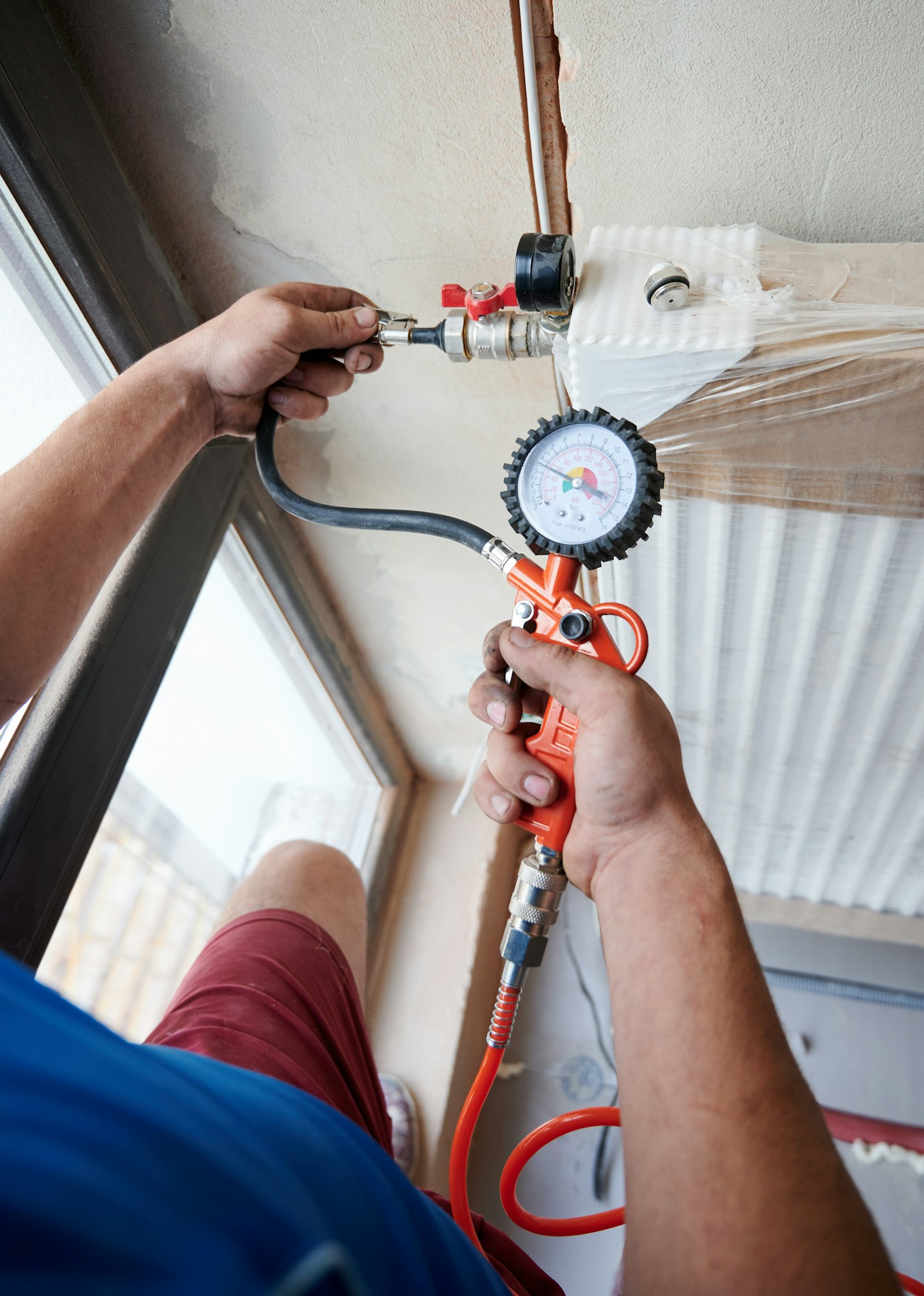 male-plumber-checking-gas-tightness-of-heating-system-