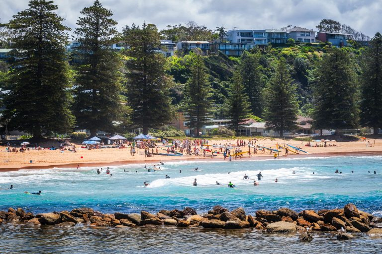 people swarming on a popular beach destination